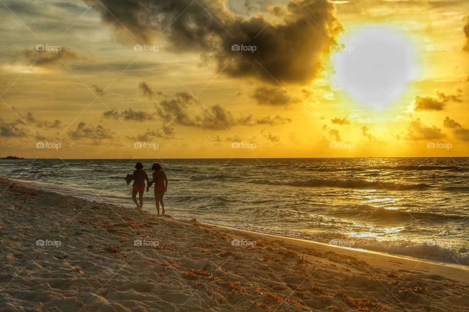 walking in the beach at sunrise