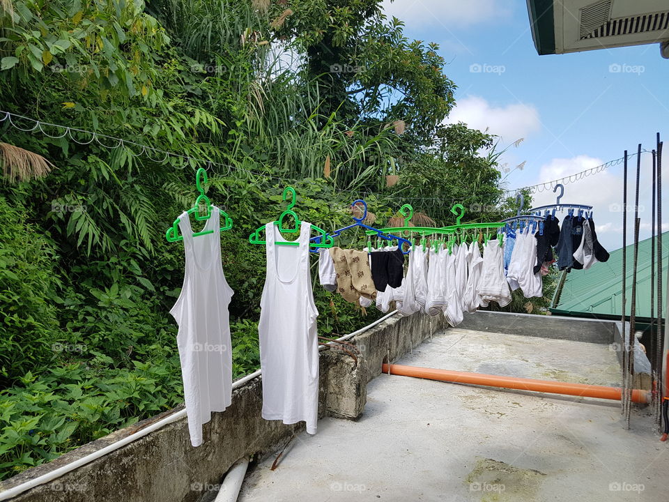 Laundry hanged to dry under the sun. Hopefully the rain won't come early.
