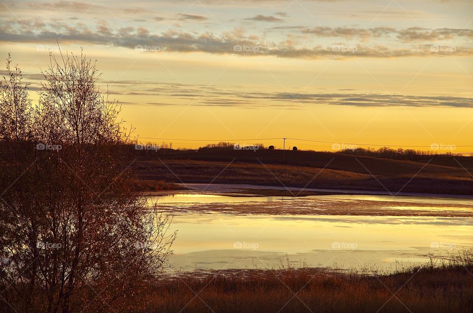 Prairie sunrise on pond