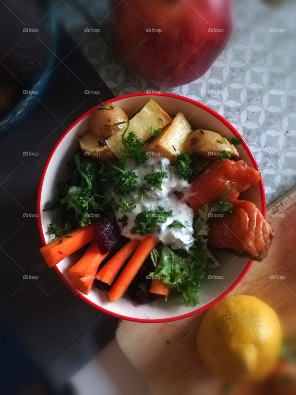 Bowl with smoked salmon, cream cheese, carrots and potatoes
