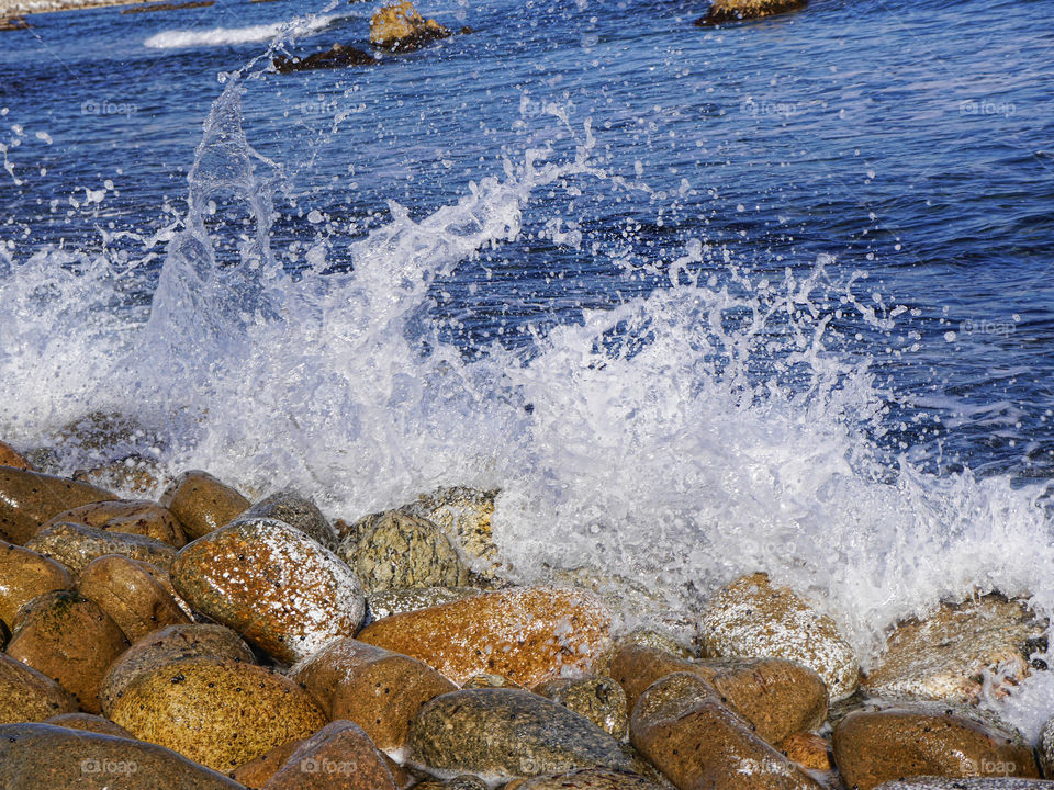 Waves splash on stones
