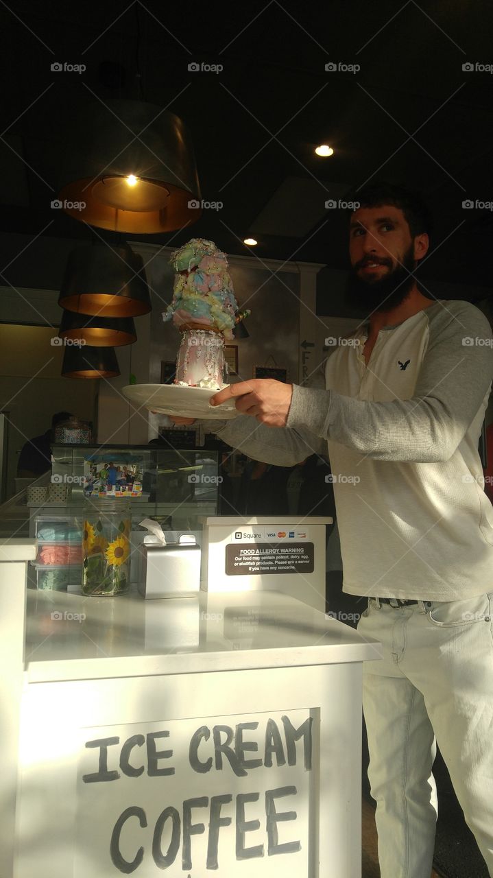 Young man holding ice cream in hand