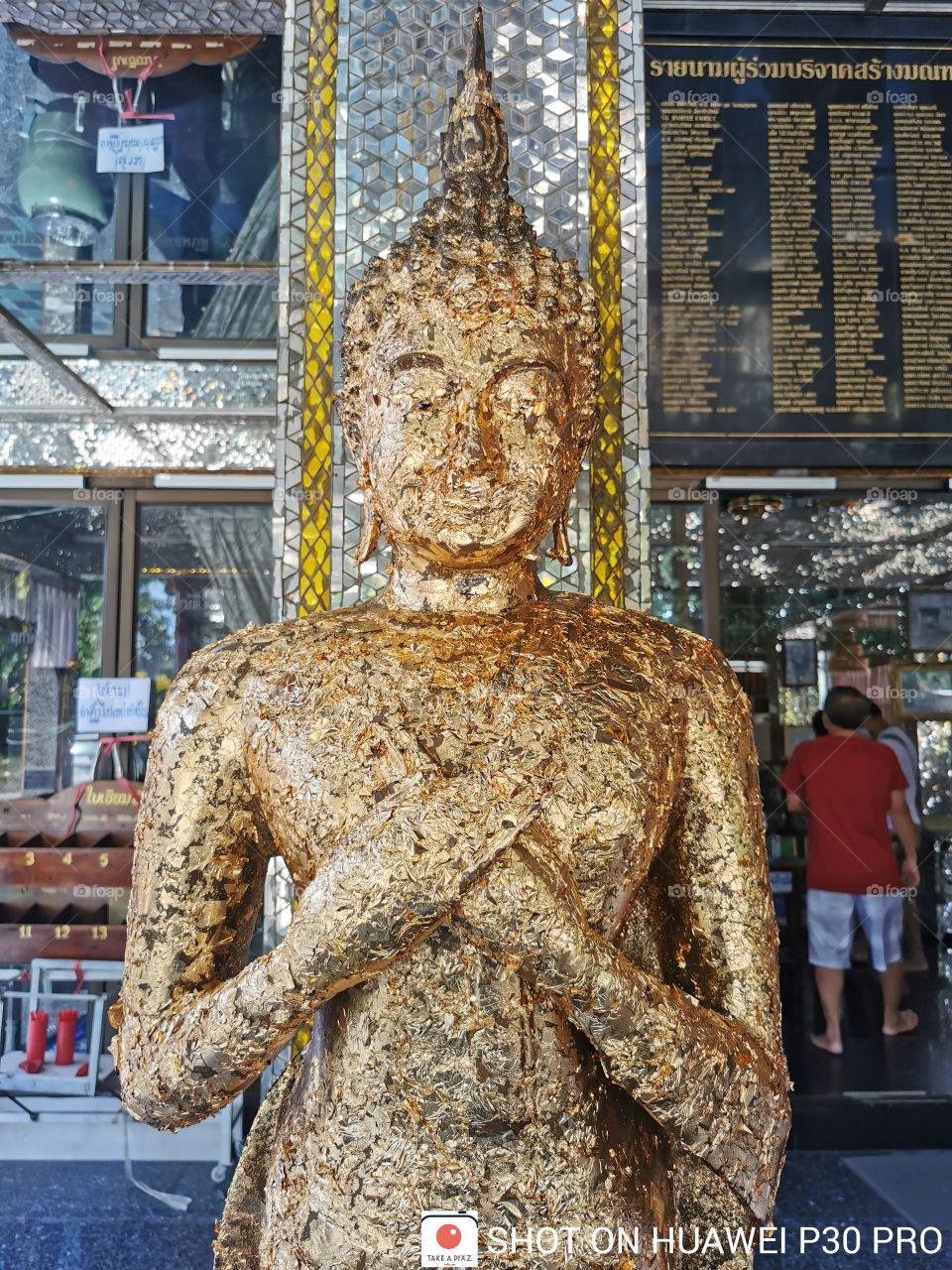 Standing Buddha statue worshiping the Thai Buddhists