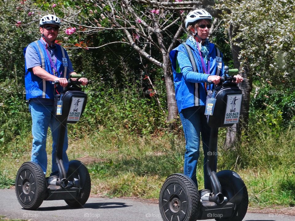 Riding A Segway. Tourists Riding The Segway Transportation Vehicle
