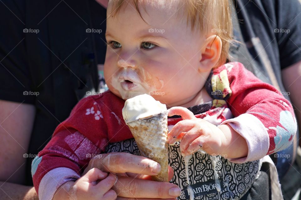 Messy Baby Girl Eating Vanilla Ice Cream
