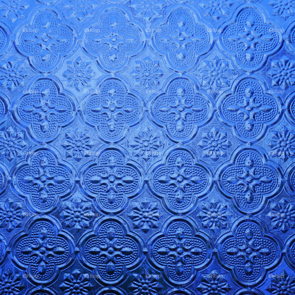 Blue color glass with thai style pattern