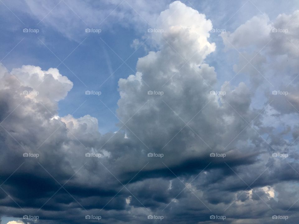 Towering clouds with dark undersides looming overhead before a rain storm