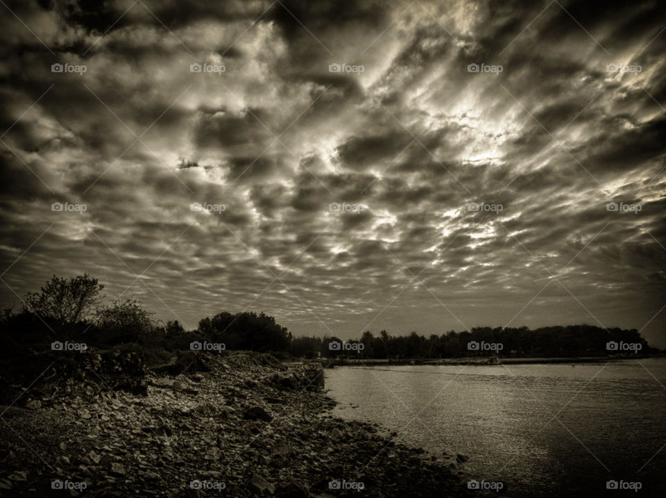 Scenic view of lake against cloudy sky