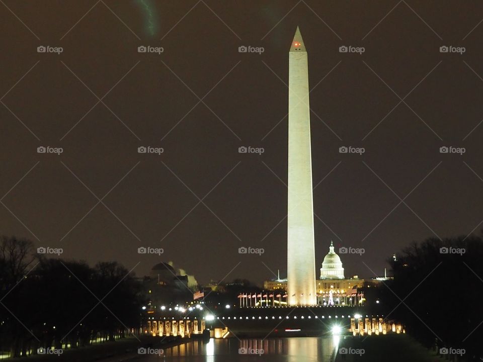 The Washington Monument and US Capitol at night.