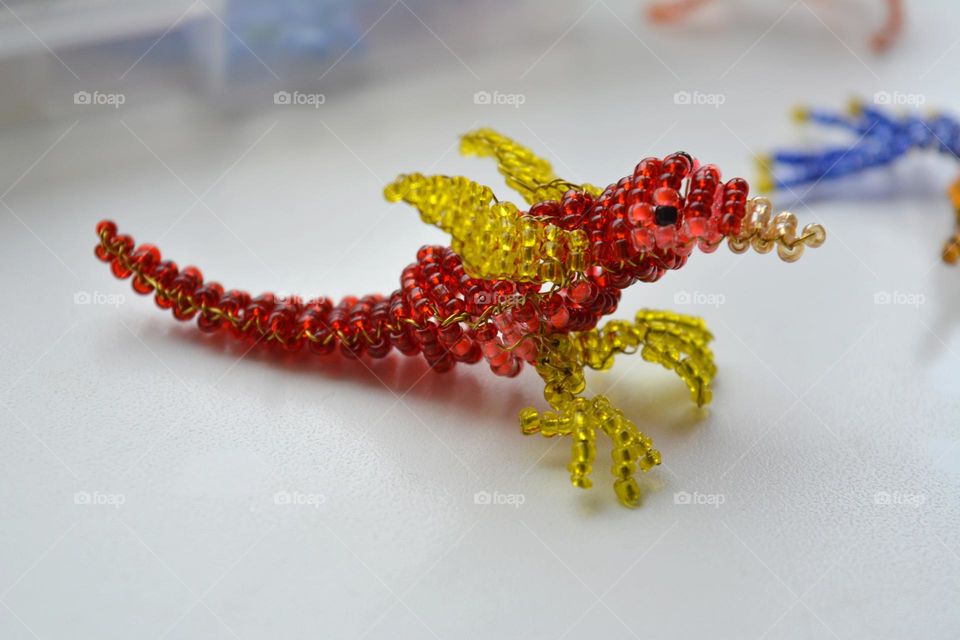 animal dragon figured from beads on a white background, art and craft hobbies