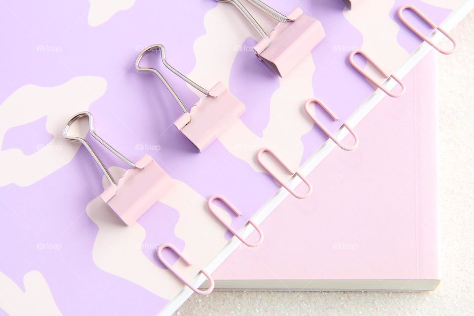 Baby pink stationery, with paper clips, paper hooks and books 