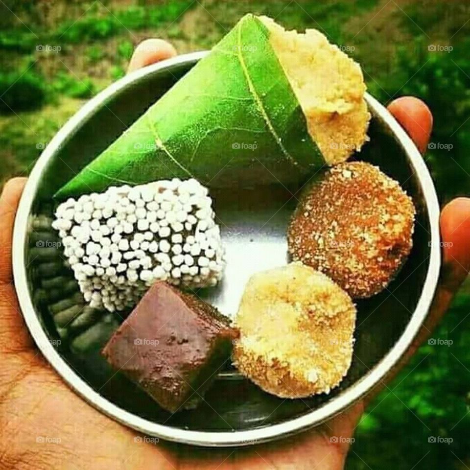 Singori or Singauri is an Indian sweet made with Khoya and wrapped in maalu leaf. Bal Mithai is a brown chocolate-like fudge, made with roasted khoya, coated with white sugar balls. Both are popular sweets from Almora, Uttarakhand, India.