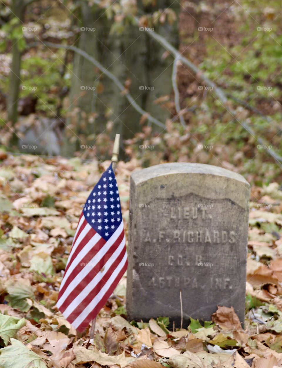 American Flag beside an old grave 