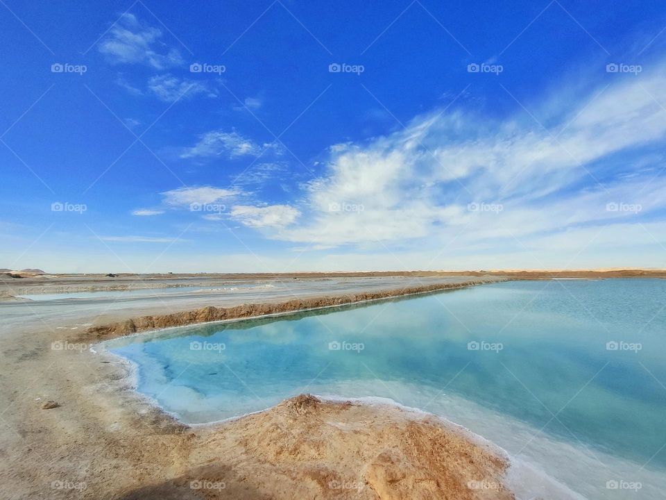 Siwa salty spring and skattered clouds