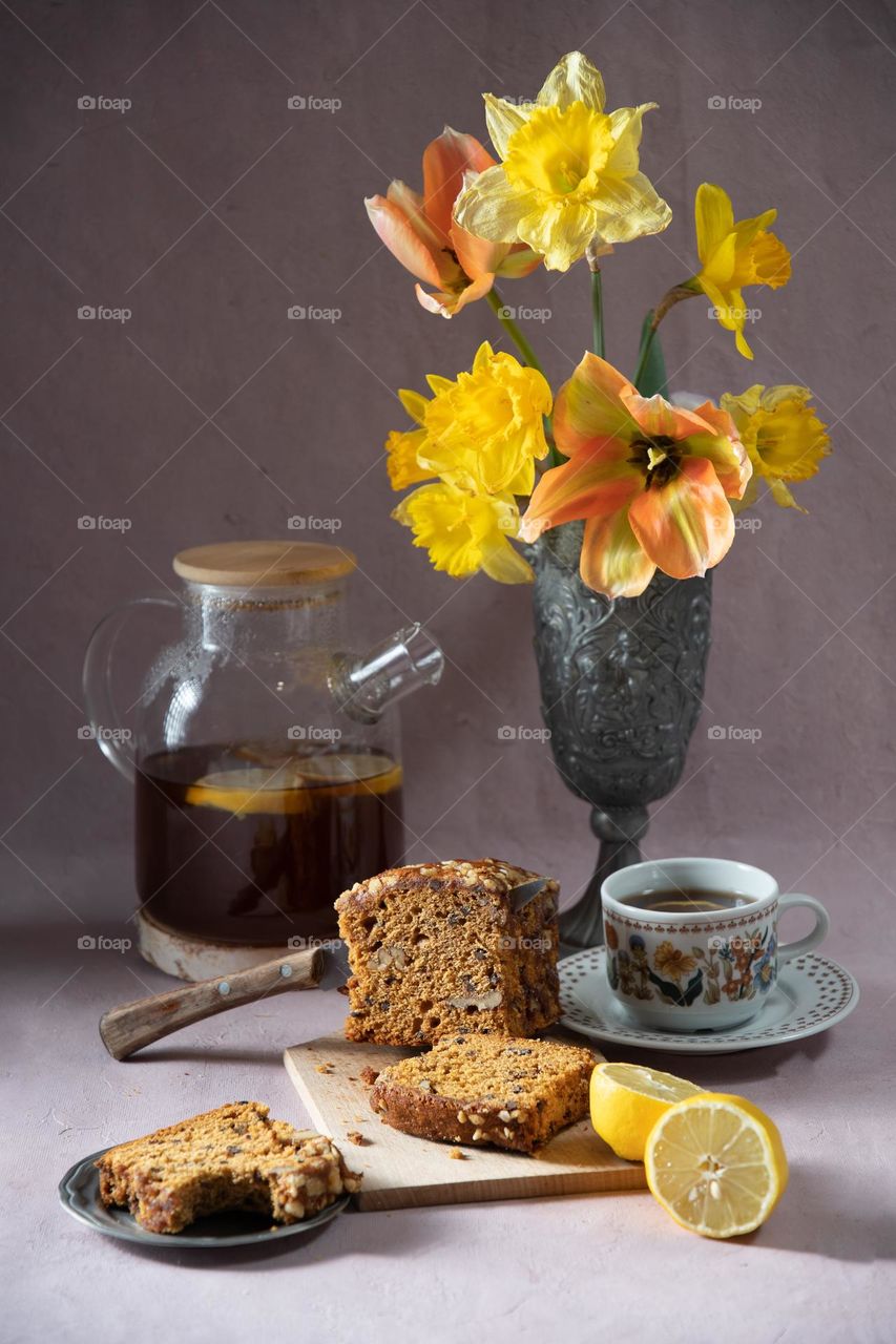Peppered traditional Belgian muffin, breakfast or brunch, tea ceremony, coffee break, bouquet with tulips and daffodils, early spring mood, easter theme, beautiful table setting, vintage still life