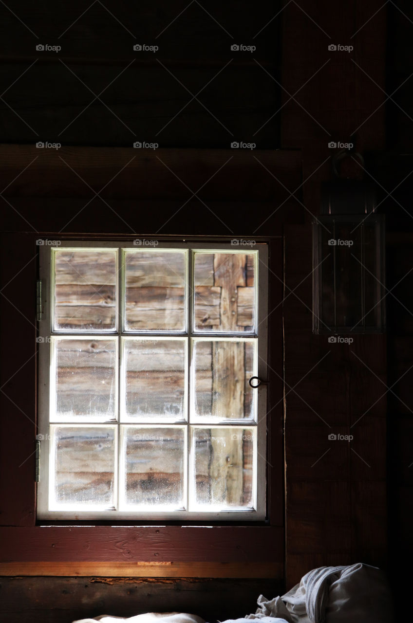 Old barn window in the shadows