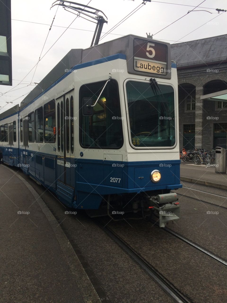 Tram number 5 arriving at tram station at Zurich Enge Hauptbahnhof in Switzerland transporting commuters 