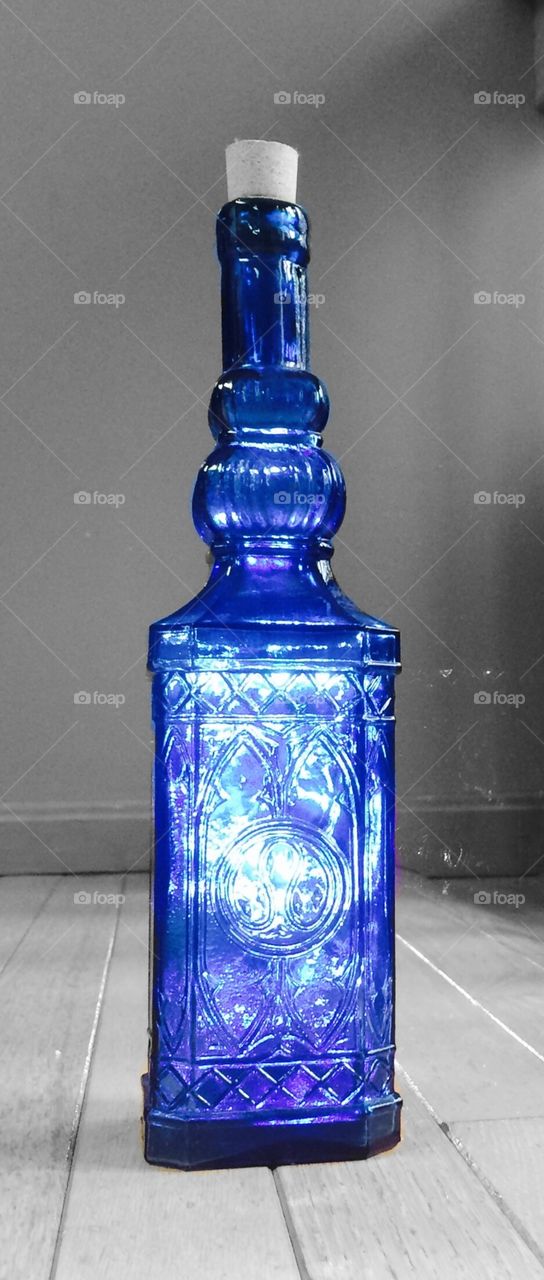 Light illuminates blue bottle