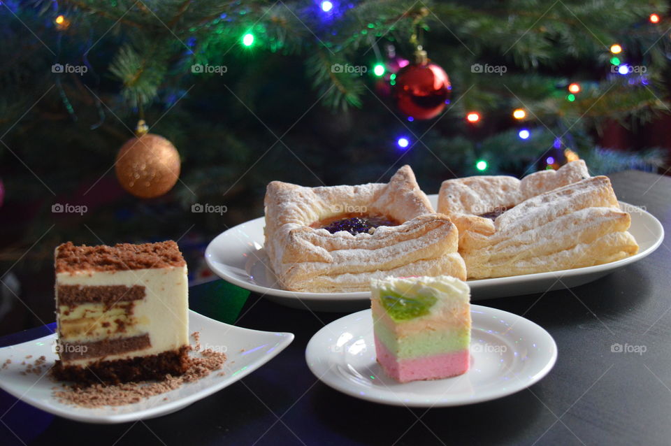 Variety of sweets near christmas tree