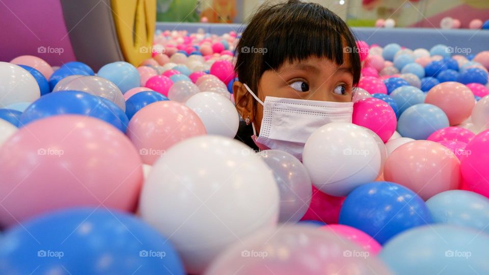 Play in a pool filled with colorful balls at the indoor playground