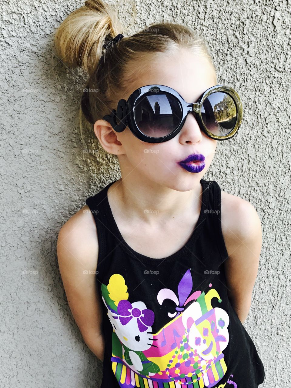 Close-up of a pouting girl wearing sunglasses