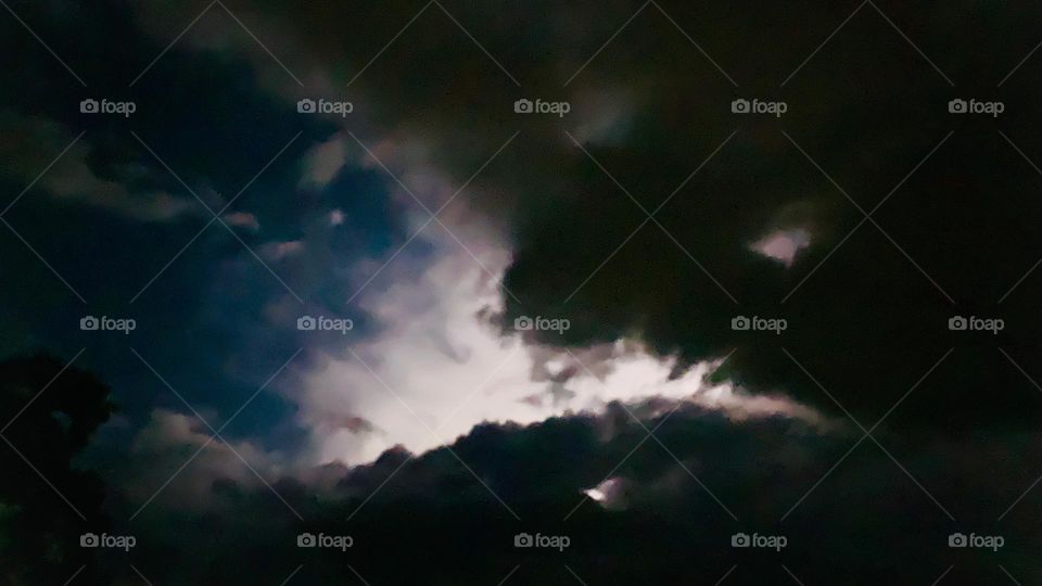 Southeastern Florida Electric Storm High Altitude Lightenings On Top Of The Clouds At Night With White, Purple And Blue Color Lights.