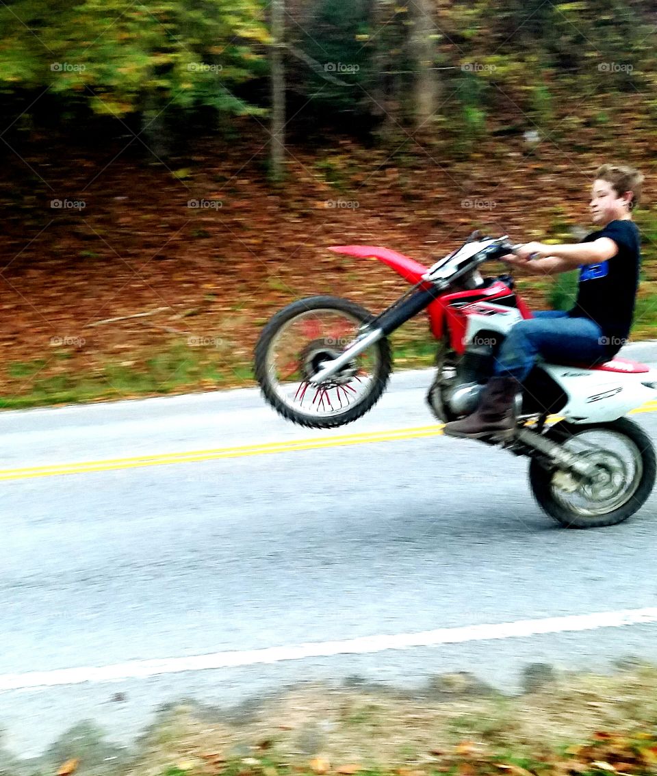 Teenage boy riding motorcycle