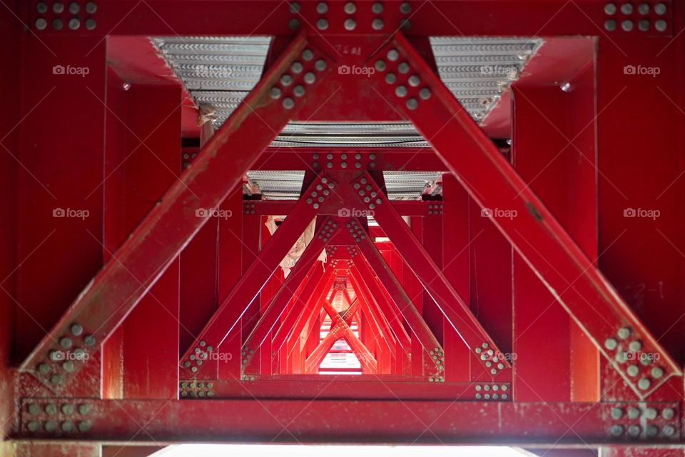 Red metal structure under the bridge 