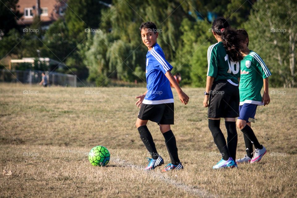 Happy kid is playing soccer