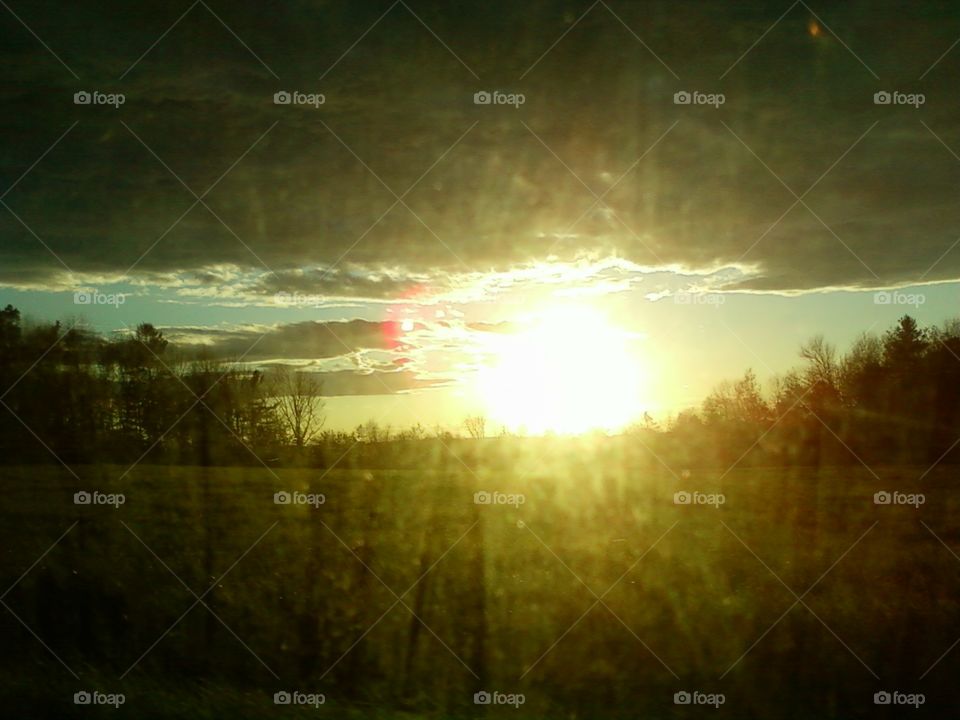 My point of view of the sun setting through a window