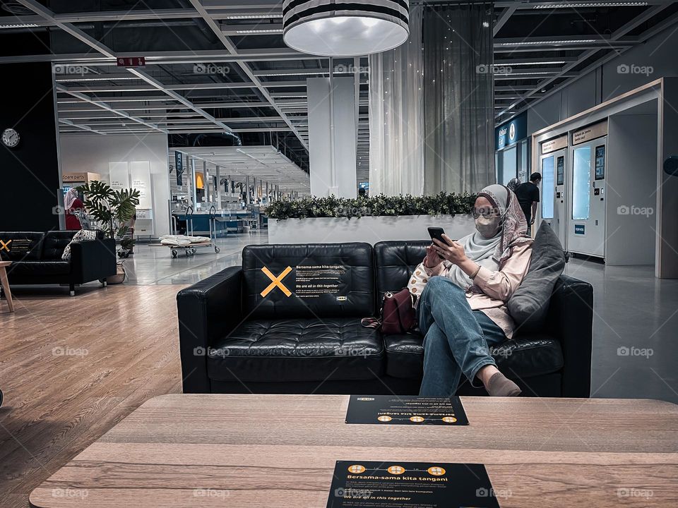 Enjoying the holiday in a shopping centre sitting on a couch