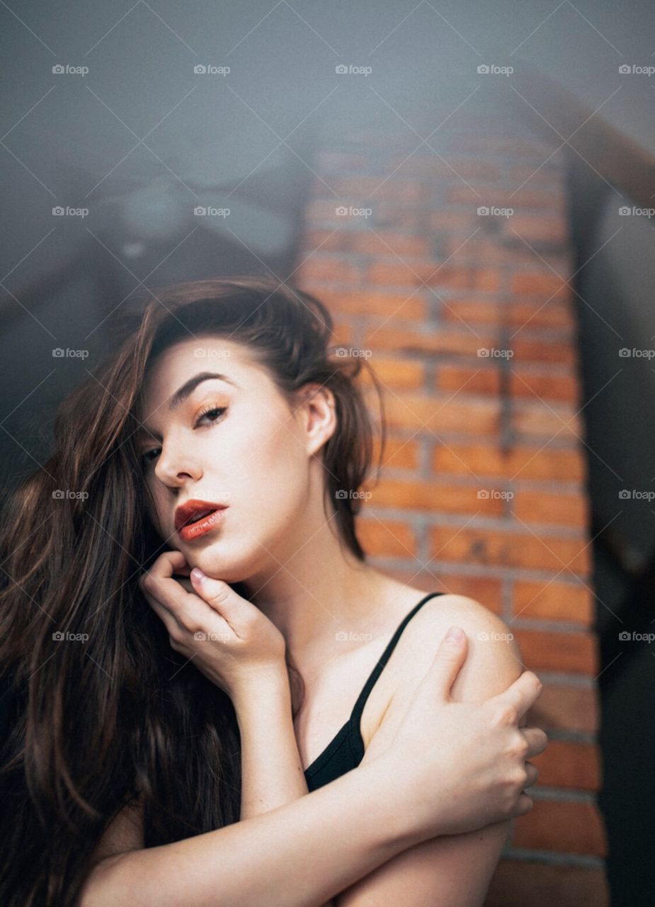 Brunette girl in moody lighting. 