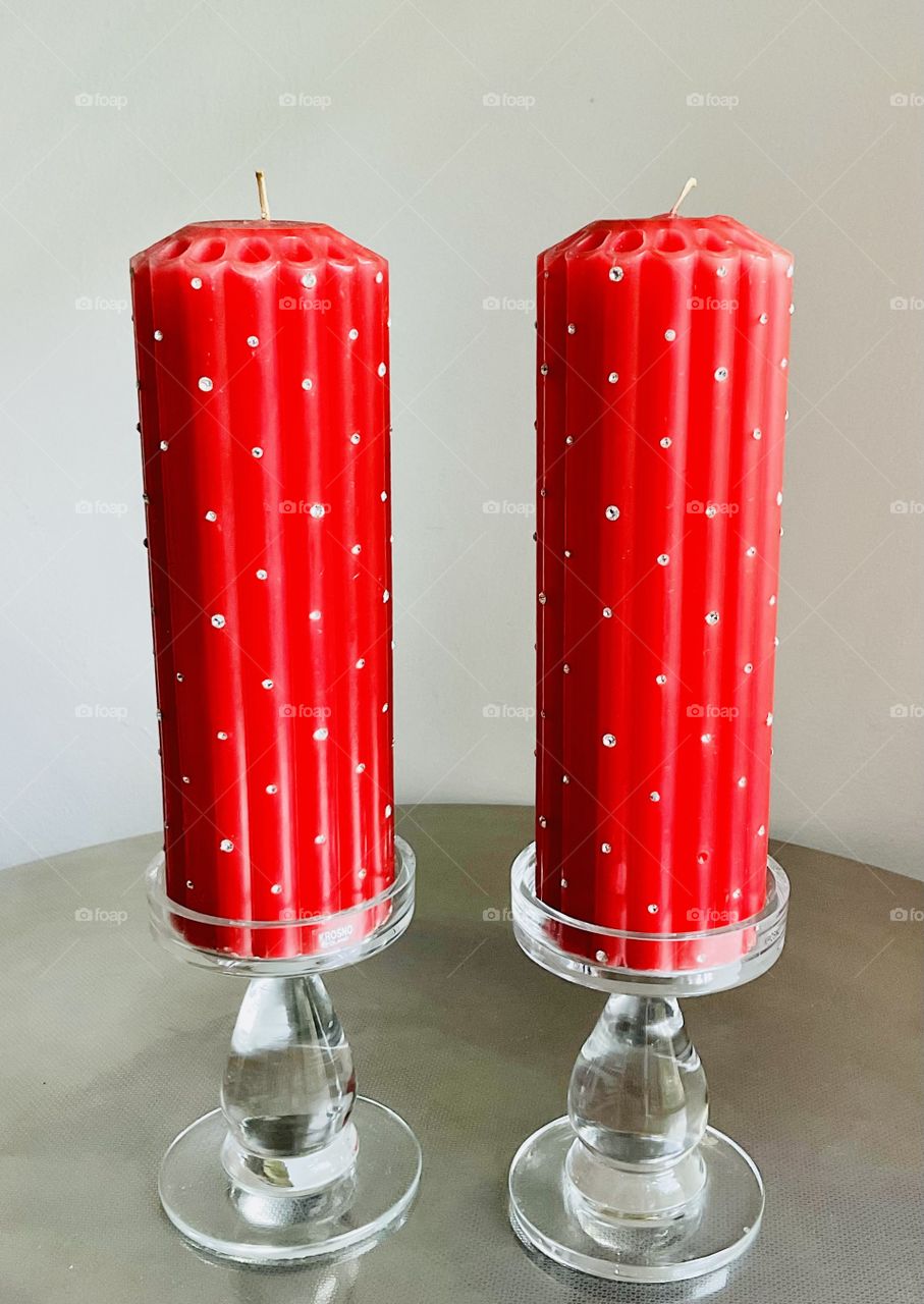 A pair of festive candles. Bright red pillar candles studded with rhinestones to add some bling. 