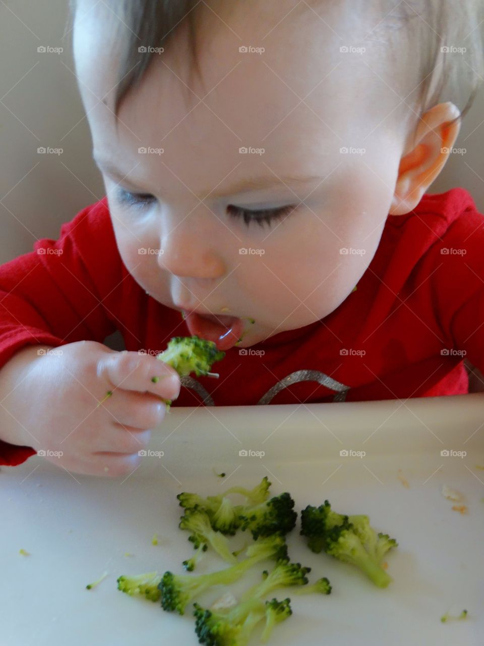 Baby Eating In A Highchair
