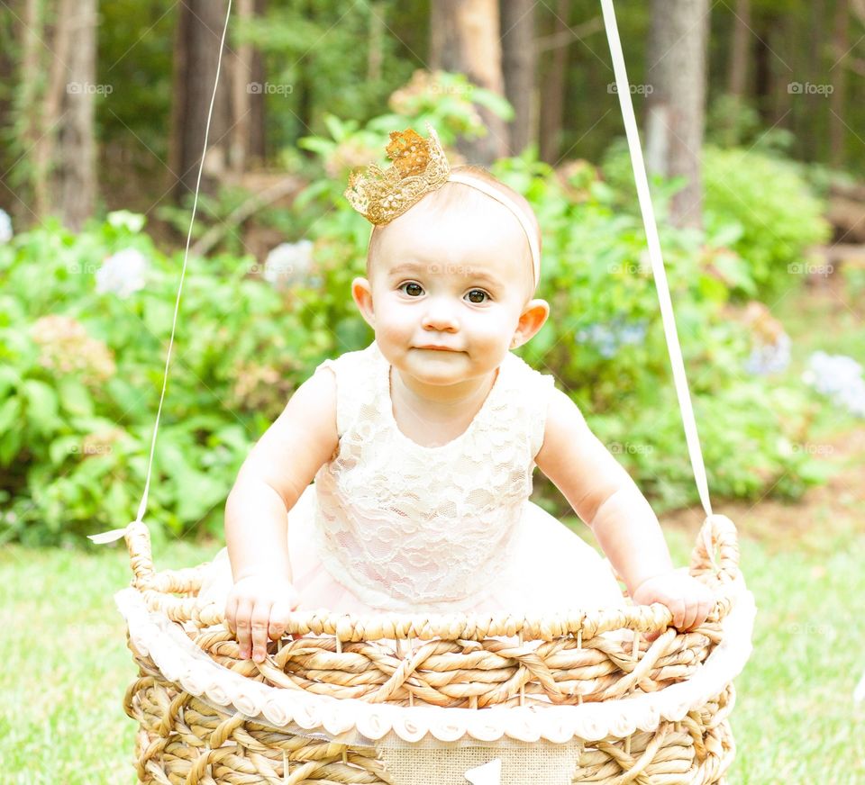 Cute little girl holding wicker basket