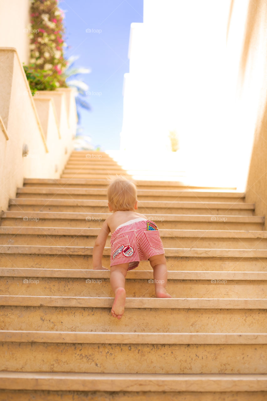 Rear view of a baby on staircase