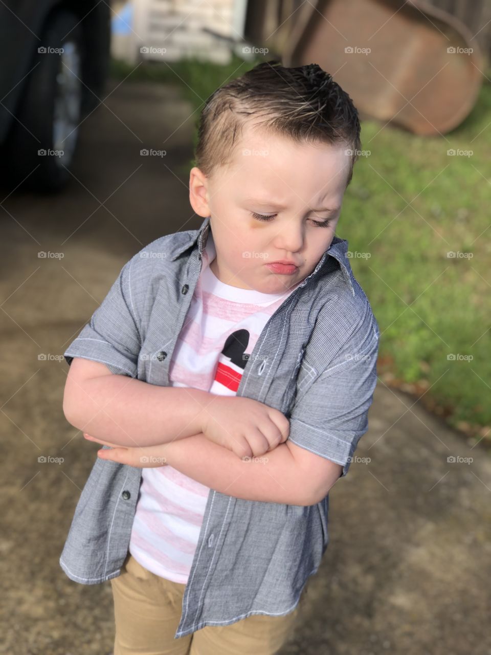toddler boy outside, modeling the pouty lip, grumpy model 