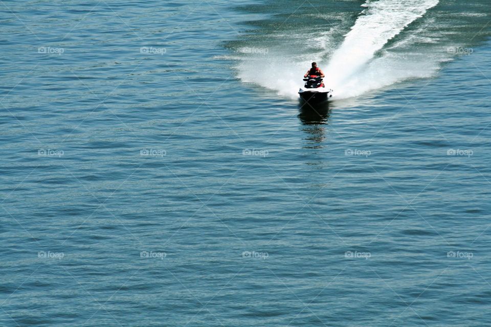 Jet Ski Fun. Out on the lake just having some fun, making waves on the Jet Ski.