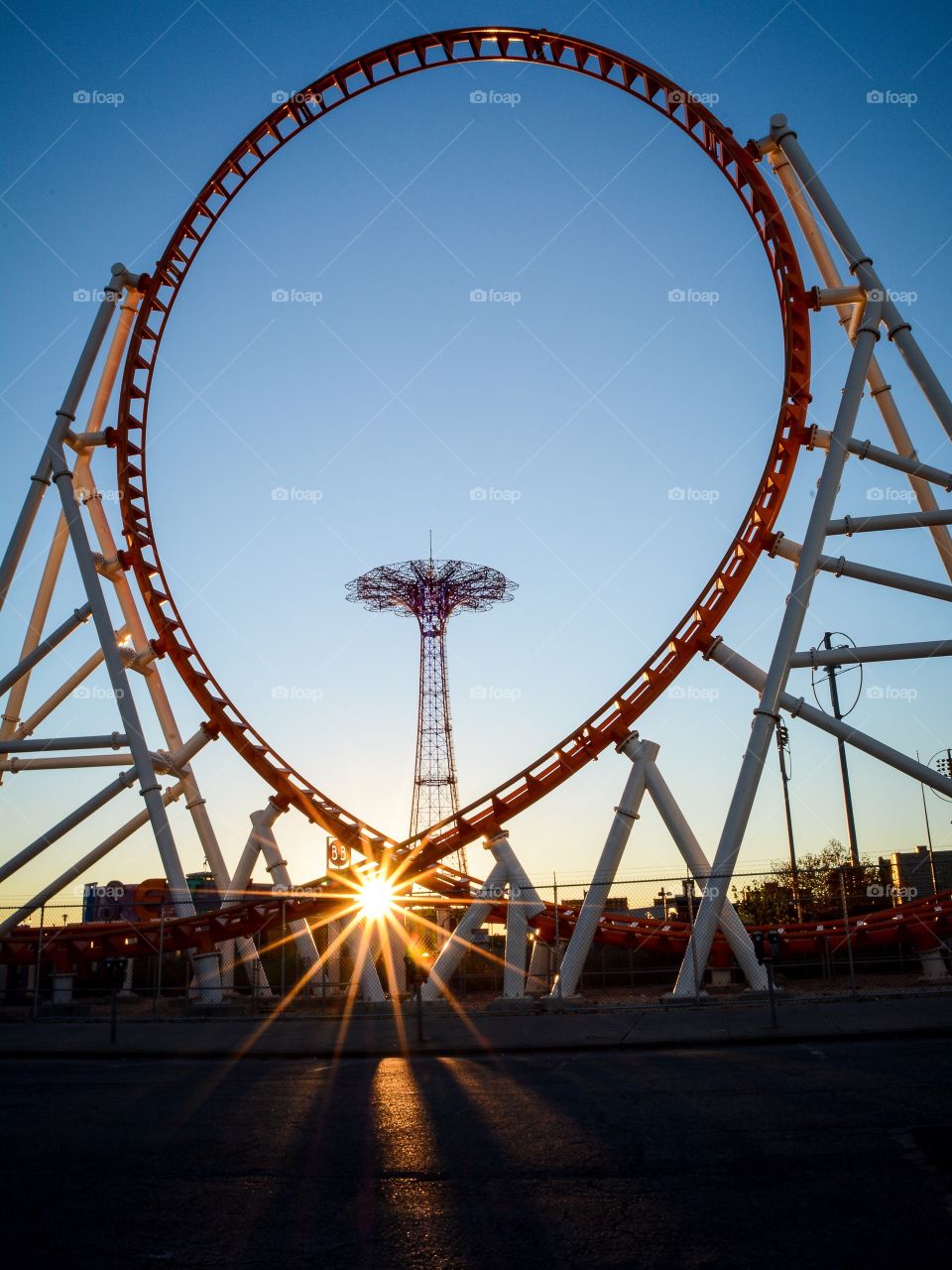 Coney Islands parachute jump through the Thunderbolt ride in midst of a beautiful sunset