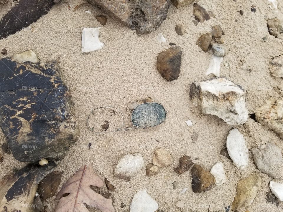 sun glasses in the sand