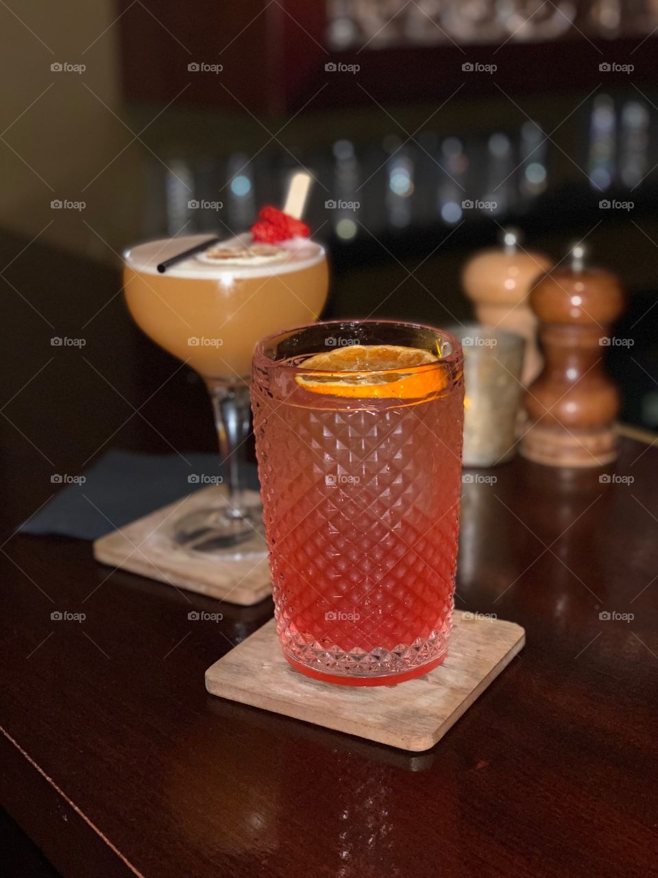 Two orange cocktails on the bar