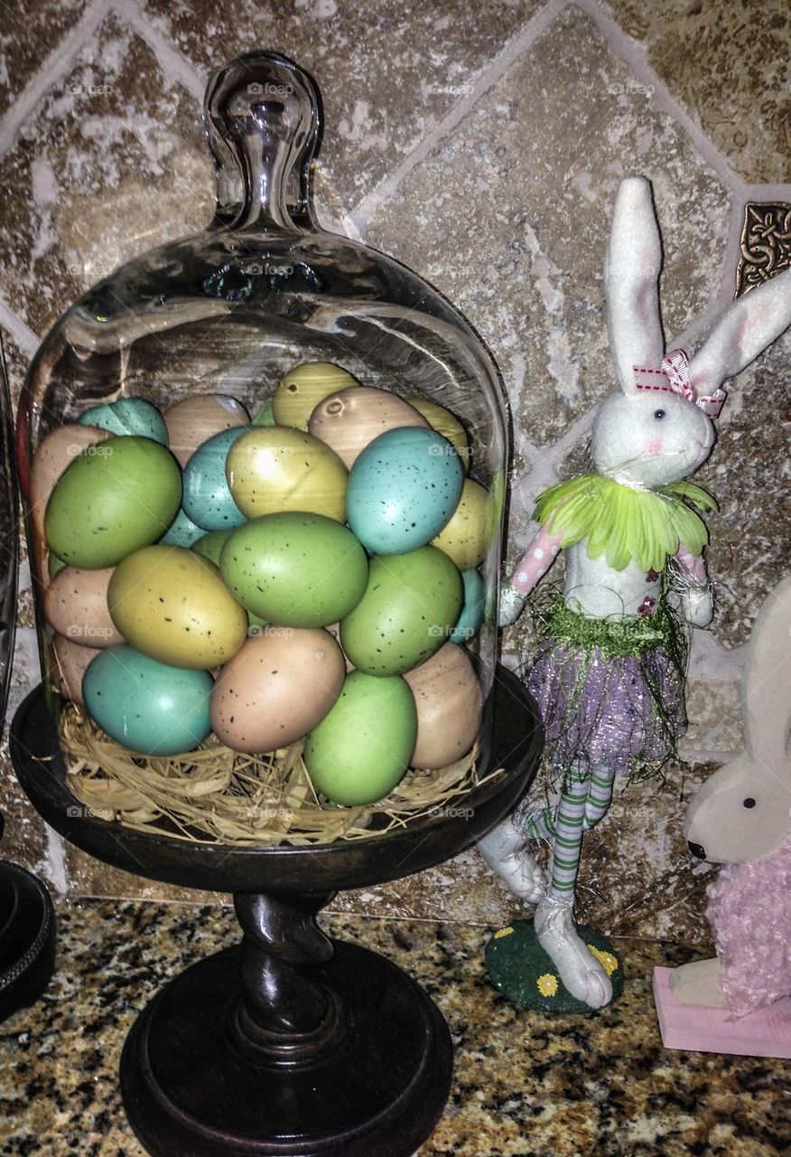 Easter eggs under glass with a bunny