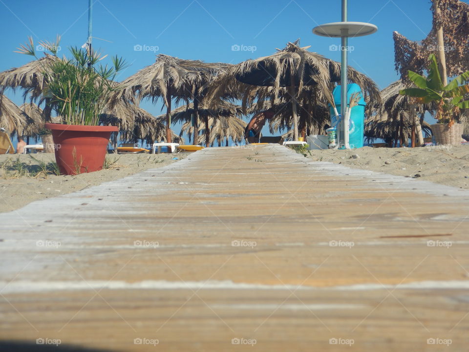 sunbeds on beach  and walking path