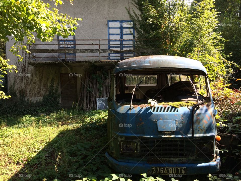 A 1960's bus overgrown in the forest near Annecy, France.