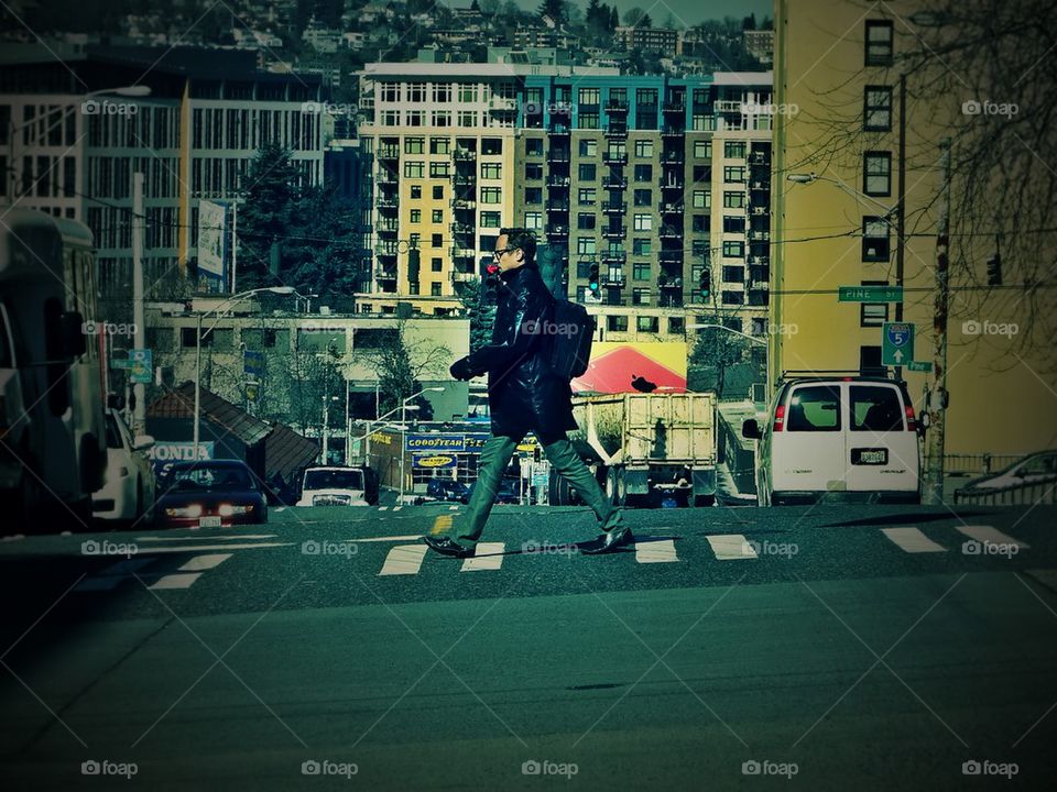 a young man crossing the street