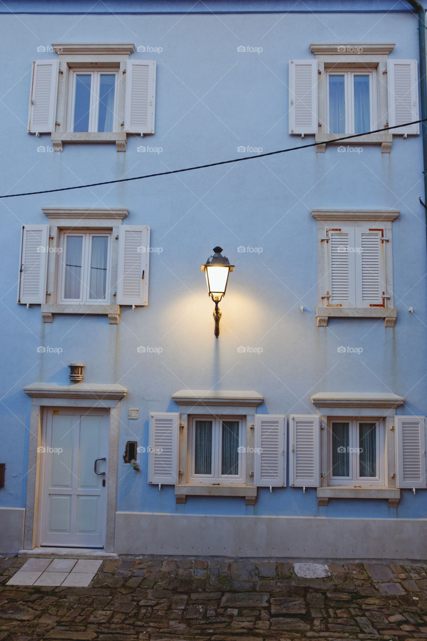 Beautiful vintage lantern on a blue house in the old town on the Adriatic coast, in Piran.