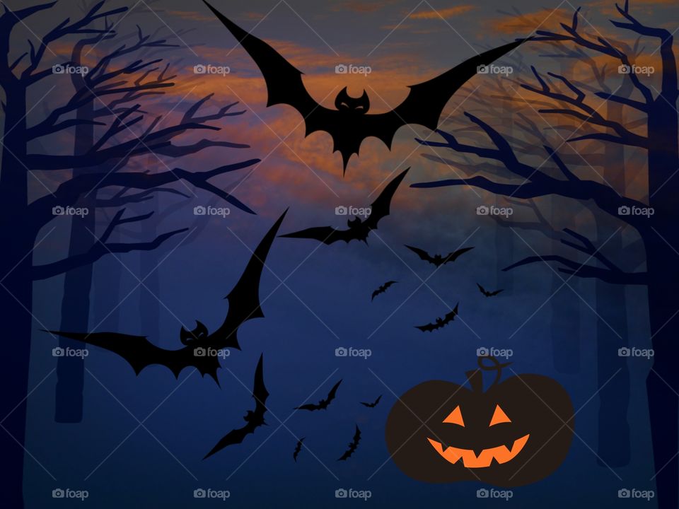 Silhouette of bat flying with spooky background