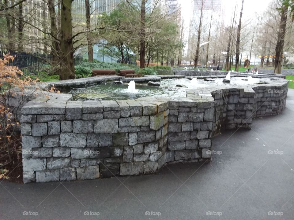 Water fountain outdoor garden with stone design at Canary Wharf
