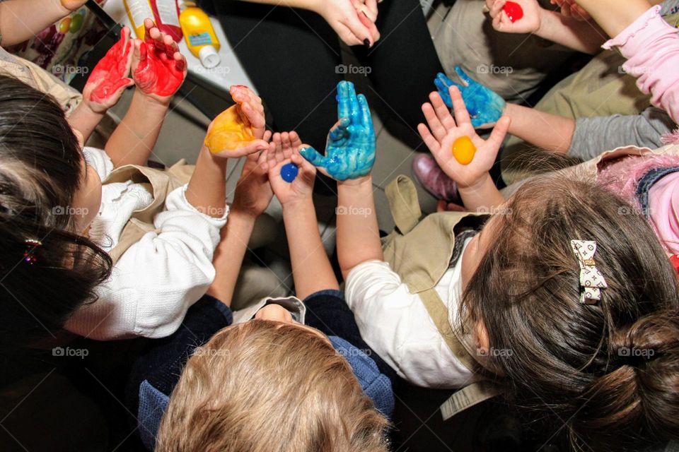 children's hands are stained with bright colors