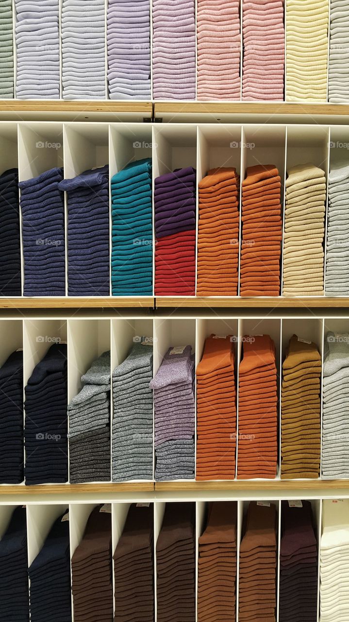 Multi colored socks in shelf for sale in store